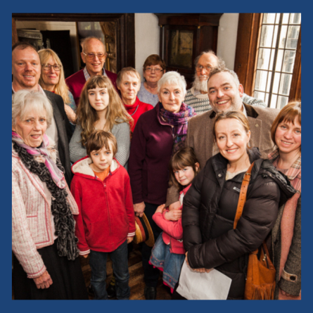 An image of a group of members of the Friends of Totnes Museum smiling at the camera.