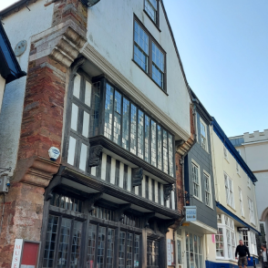 An image of the front of Totnes Museum looking up the Fore Street towards Eastgate