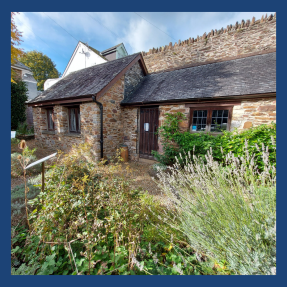 An image of Totnes Archive from the Garden during a sunny day